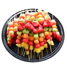 fruit skewers are arranged on top of each other