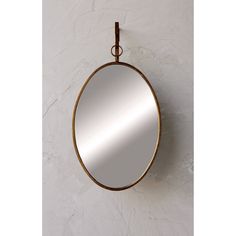 a round mirror hanging on the wall