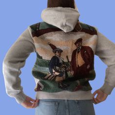 the back of a person wearing a sweater with an image of two men on it