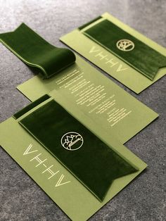 two green envelopes with the words wh and wh on them sitting next to each other