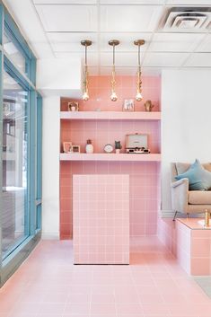 a living room with pink tiles and shelves