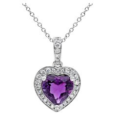 A beautiful and versatile pendant necklace showcasing a vibrant 1.72 carats heart shape purple amethyst in the center, set in a classic three prong setting. Surrounded by a single row round brilliant diamonds and hanging by a diamond encrusted bail weighing 0.22 carats total, F color and VS in clarity. Suspended on a 14k adjustable white gold chain and Finely made in 18k white gold. Roman Malakov is a custom house, specializing in creating anything you can imagine. If you would like to receive a special quote on a custom piece please message or call us. Formal Purple Heart Pendant Necklace, Heart Pendant Amethyst Jewelry, Amethyst Heart Pendant Necklace, Purple Gemstone Heart Pendant Jewelry, Purple Heart-shaped Amethyst Necklaces, Beautiful Pendant Necklace, Halo Pendant, White Gold Chains, Heart Pendant Necklace