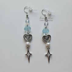 "Handmade Beaded Earrings ✿ Made with glass beads, freshwater pearls, and metal accents ✿ Silver, ice blue, and pearlescent white ✿ The earrings are \" long Fish Hook Options ✿ The Titanium fish hook is hypoallergenic and ideal for sensitive skin ✿ The regular fish hook is made of nickel free metal, it is not hypoallergenic" Earring Inspo, Ears Pierced, Handmade Beaded Earrings, Helpful Things, Handmade Earring, Handmade Earrings Beaded, Homemade Jewelry, Metal Accents, Jewelry Inspo