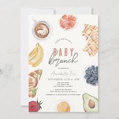 a baby shower is shown with fruits and other things to eat on the front of it