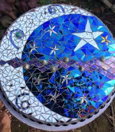 a blue and white mosaic sun catcher with stars on it