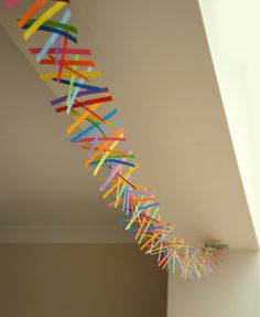 colorful streamers are hanging from the ceiling in this room with white walls and flooring