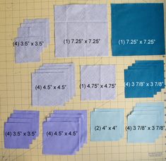 several pieces of cloth laid out on a cutting board with numbers and measurements for each piece