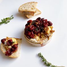 bread and cranberry toppings sit on a white surface