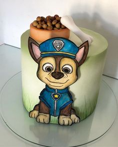 a cake decorated with a dog wearing a police uniform and nuts on top of it