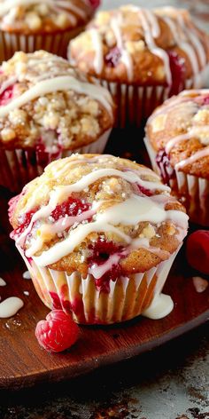 raspberry muffins with icing on a wooden plate