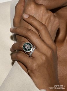 The Tate Cocktail Ring features a 2.5-carat oval lab-grown white sapphire, encircled by oval emeralds and round white sapphires or diamonds. Holiday Production Time: This made to order ring ships 5 - 7 weeks from purchase date. Please place your order by November 1st for guaranteed delivery before December 25th. Orders placed after this date cannot be guaranteed to arrive in time for the holidays. Custom styles can only be returned for store credit.The Fine Print: Metal: 18k gold coated silver o Two Carat Engagement Ring, Art Deco Ring Engagement, Red Sapphire Ring, Jewelry Rings Unique, Big Stud Earrings, Yellow Sapphire Rings, Gold Sapphire Ring, Red Sapphire, Emerald And Diamond Ring