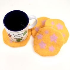 coffee cup and coasters on a white surface