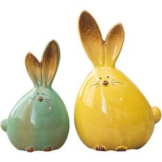 two ceramic rabbits sitting next to each other