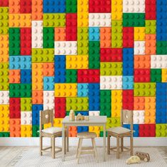 a lego wall mural in a child's room with two chairs and a table