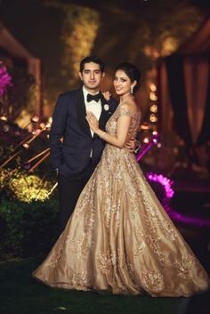 two people standing next to each other in formal dress and tuxedo, posing for an instagram