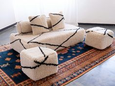 a couch and ottoman sitting on top of a rug