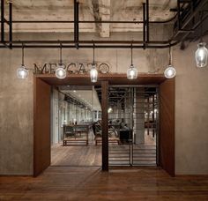 the entrance to an office building with wooden floors and glass doors that lead into it