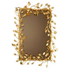 a gold framed mirror with leaves on it