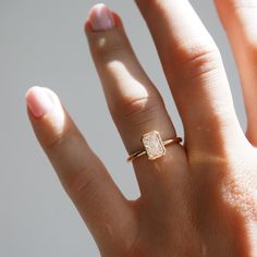 a woman's hand with a yellow diamond ring on top of her left hand