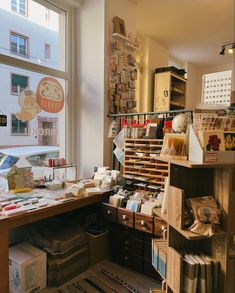 a room filled with lots of clutter next to a window