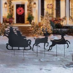 a christmas yard decoration with sleigh and reindeers