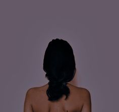 the back of a woman's naked torso with no shirt on