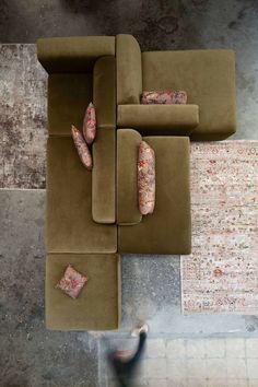 an overhead view of a living room with couches and rugs on the floor