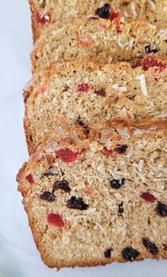 slices of fruit and oatmeal bread sitting on top of a white plate