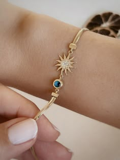 The bracelet made of 14K solid gold draws attention with its sun and evil eye bead figures. The sun symbol and the blue evil eye bead, decorated with shiny stones, bring elegance and protection together. Perfect for both daily and special occasions. 🎁 PRODUCT DETAILS ✪ Handmade / Handcrafted Fine Jewelry  ✪ Gold Weight: Approx. 4.57-6.0g   ✪ Metal:  14K Solid Gold   ✪Width of each Bangles:   ✪ Length of the each Bangles: 4-10 inches   ✪ Gold Color: White gold, Rose gold, Yellow gold 🎁 QUALITY We use 14K real gold. (8K or 18K for some jewelry) We do not gold-plat silver or other metals. We do not produce gold-plated products. ‣ We guarantee the quality of our jewelry. 🎁 SHIPPING AND PACKAGING ✪ All orders will be shipped via express shipping with tracking. ✪ 95% of the orders we ship are Evil Eye Gold Bracelet For Women, Gold Breclates Girl, Braclet Designs For Girls Gold, Gold Breslate Design For Women Pakistani, Bracelet For Girls Gold, Hand Bracelet Gold For Women, Girls Bracelet Designs Gold, Women Bracelets Gold Designs, Chain Bracelet Gold For Women