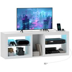 a white entertainment center with electronics on it