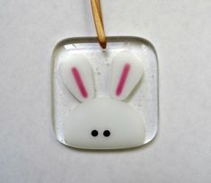 a glass ornament with a bunny face on it