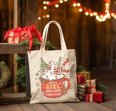 a white bag sitting on top of a wooden floor next to christmas decorations and presents