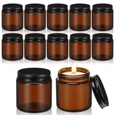 a set of twelve brown glass jars with a lit candle