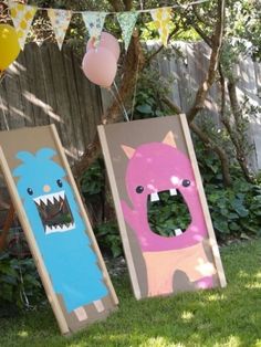 two wooden boards with pictures of animals on them, one is pink and the other is blue