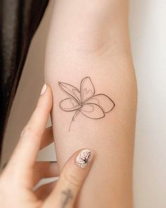 a woman's arm with a butterfly tattoo on the left side of her body