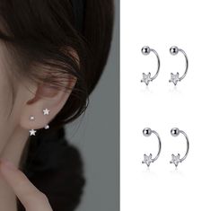 three pairs of earrings with stars on the ear and one pair is shown in white gold