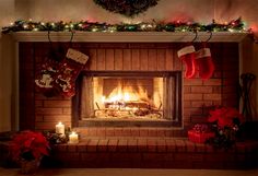 a fireplace decorated for christmas with stockings and candles