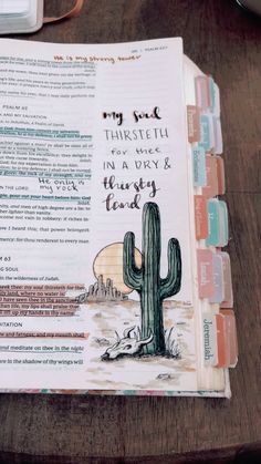 an open bible on top of a wooden table