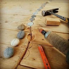 some rocks are laying on top of a wooden table next to a pair of scissors