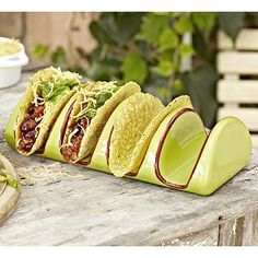 a group of tacos sitting on top of a wooden table