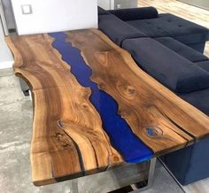 the table is made out of wood and has blue paint on it's surface