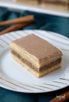 a piece of cake sitting on top of a white plate next to chopsticks