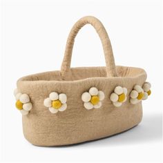 a basket with flowers on the handle and two handles, made out of wool felt