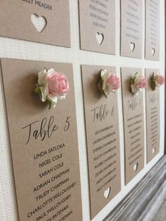 seating cards with flowers pinned to them on a wall in a restaurant or bar area