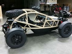 an off - road vehicle is parked in a garage with tires on the back wheels