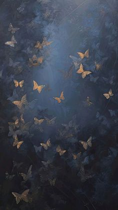 a group of yellow butterflies flying in the air with sunlight coming through them and dark background