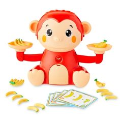 a toy monkey with bananas and cards on the ground