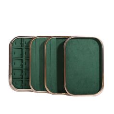 four compartments in a metal case with green velvet lining