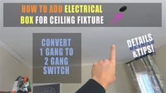 a person pointing to an electrical box for ceiling fixture