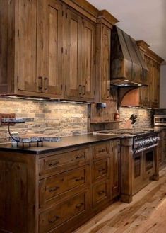 a kitchen with wooden cabinets and an island in front of the stove, oven and microwave